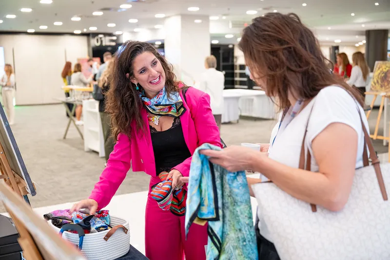 Visitors browsing an exhibitor's stand