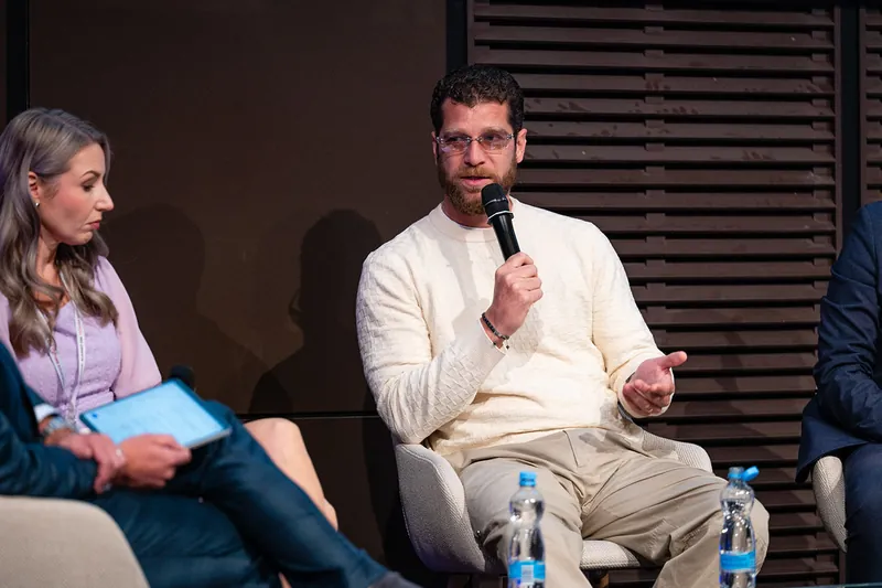 Two panellists in conversation on stage